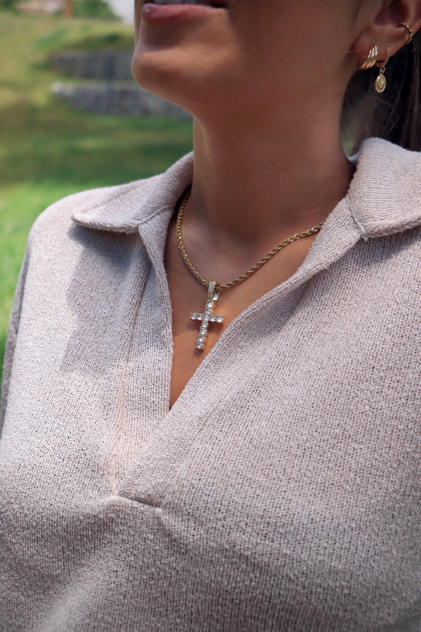 Girl wearing icy Dourado minimal cross pendant